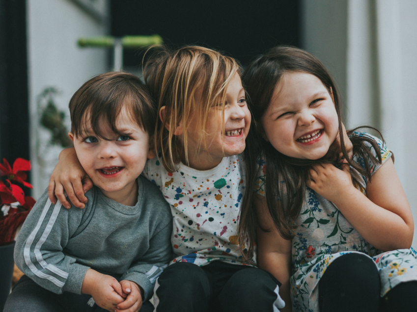 Young children hugging and smiling