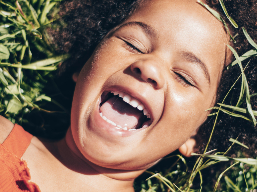 Happy child laying in the grass