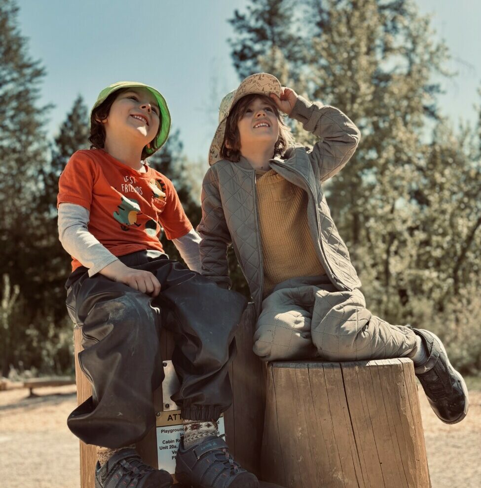 students sitting on logs