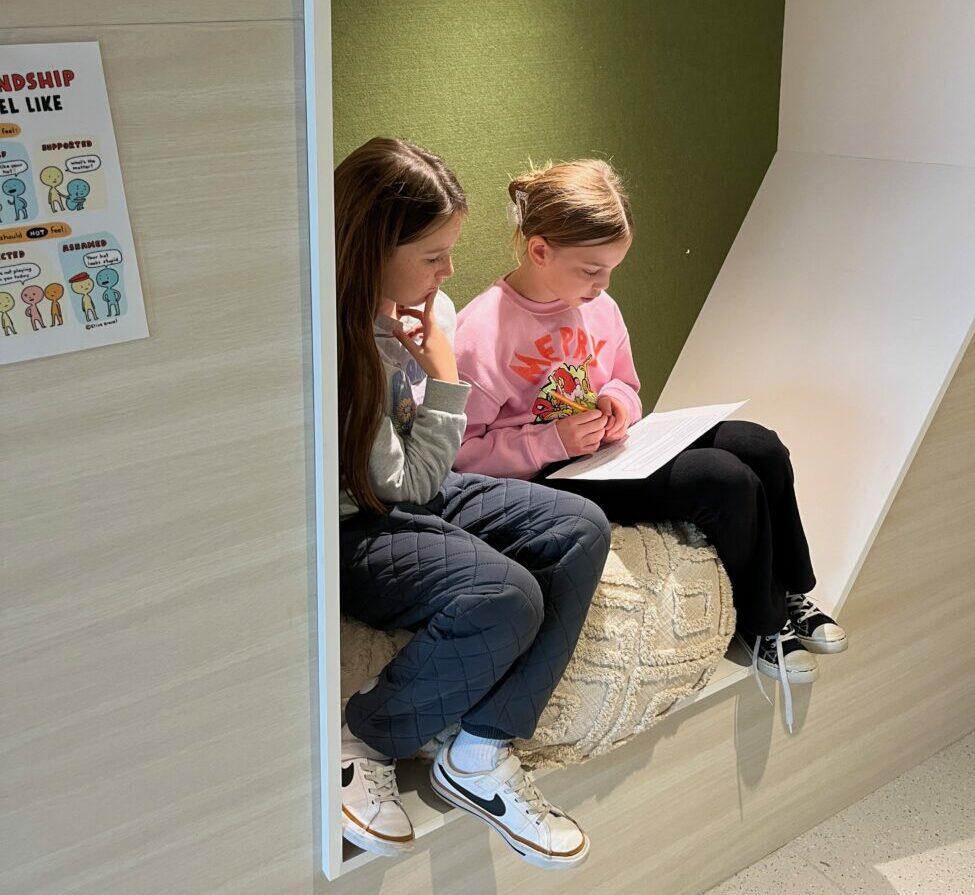 girl students in cubby in wall