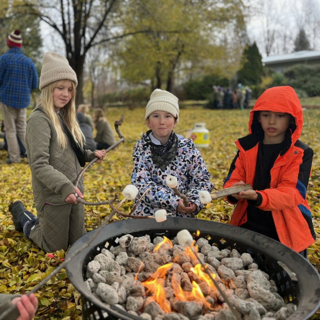 students outside by fireplace