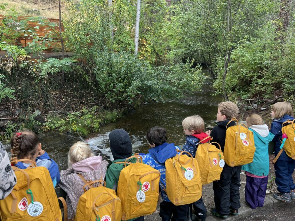 students outside by river